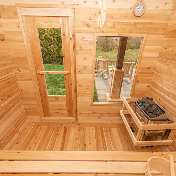 Leisurecraft traditional outdoor luxury sauna interior with wooden benches and heater stones