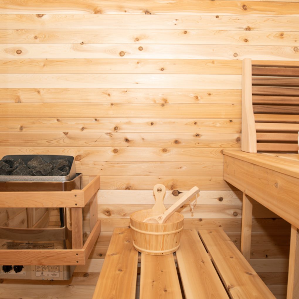 Leisurecraft traditional outdoor luxury sauna interior with wooden benches and heating stove