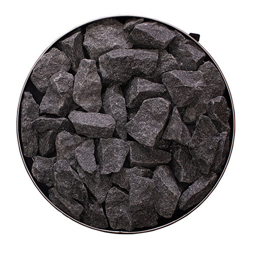 Top view of Narvi Luosto wood-burning sauna stove stone compartment filled with dark sauna rocks for heat retention