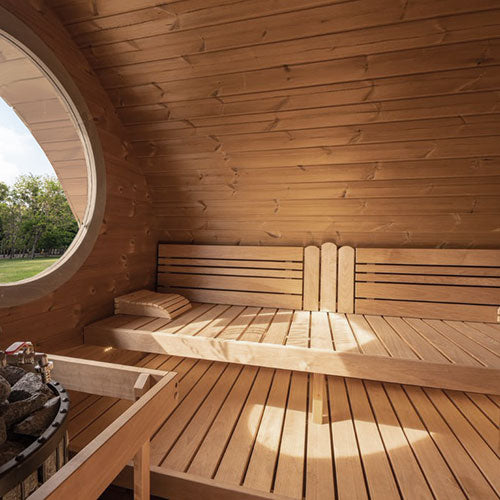 SaunaLife traditional outdoor home sauna kit interior with wooden benches and round window
