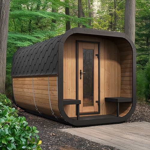 My Luxury Home Spa traditional outdoor home sauna suite with wooden exterior and curved roof in forest setting