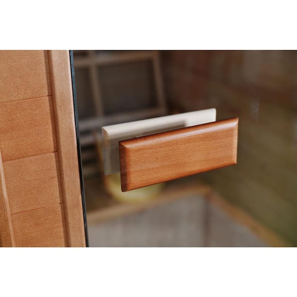 Close-up of wooden handle on SunRay 2-person outdoor sauna glass door with traditional wood finish