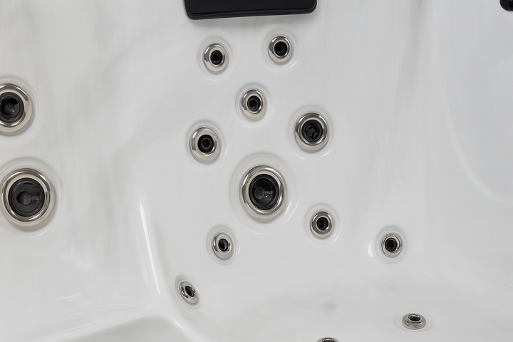 Close-up of white Luxury Spa premium outdoor hot tub interior with multiple jet nozzles
