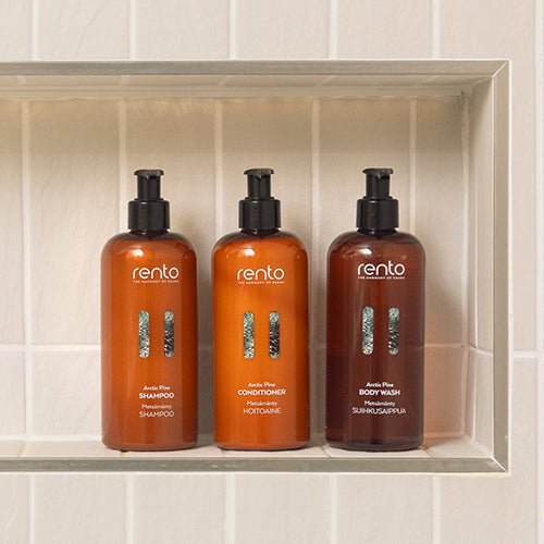 Rento Arctic Pine Refreshing Shampoo, Conditioner, and Body Wash Bottles on a Shower Shelf