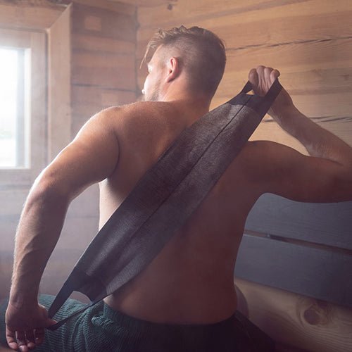 Man using Rento luxury back washer for shower in a sauna for a refreshing cleanse