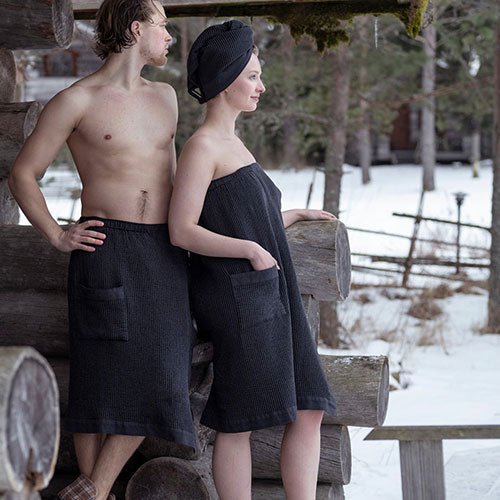 Couple wearing Rento luxury sauna sarong in black, perfect for relaxation and sauna experiences