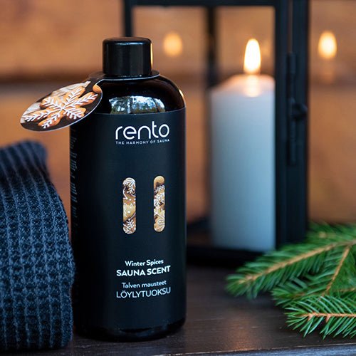 Rento sauna scent Winter Spices in a black bottle with a candle and towel for a relaxing sauna experience