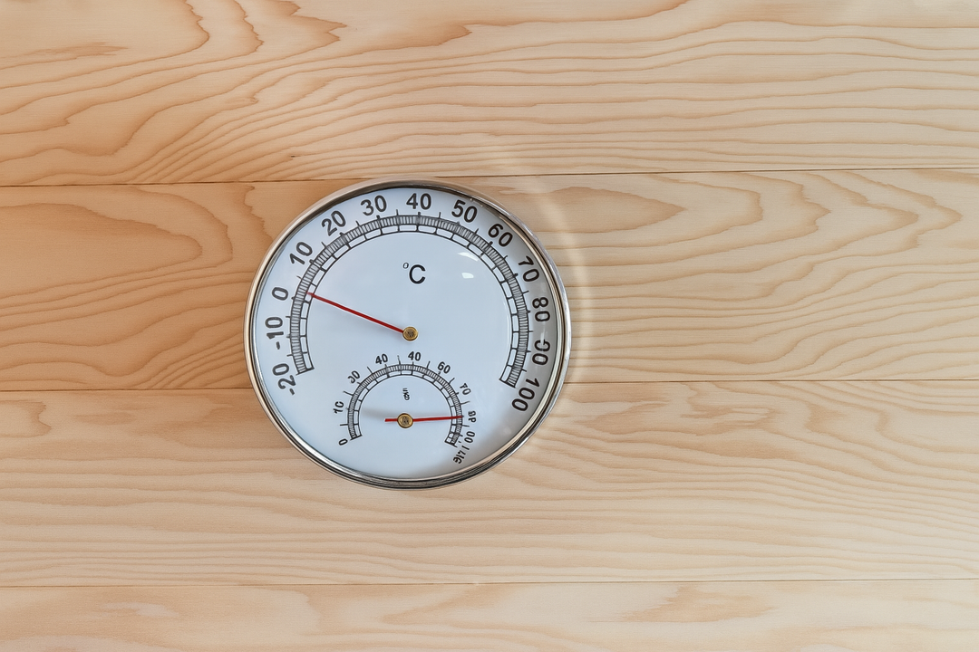 Temperature and humidity gauge inside a 3-person traditional sauna by SunRay on wooden wall