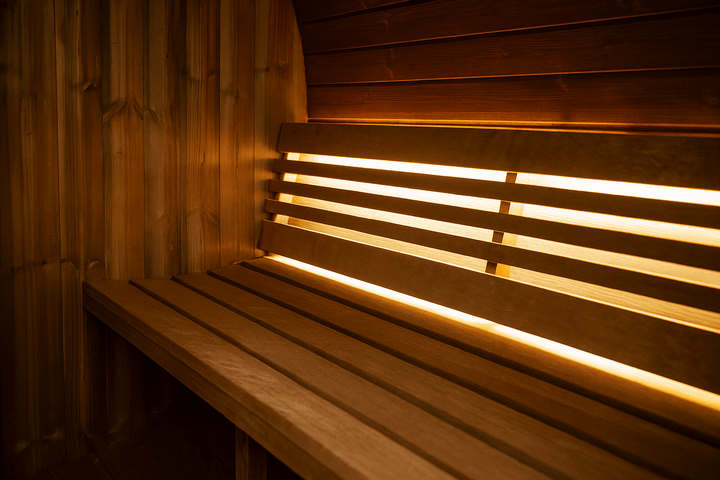 Interior view of the SaunaLife E8W sauna barrel with warm lighting and wooden benches for relaxation