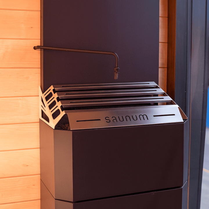 Saunum automatic sauna water dosing system mounted on wooden sauna wall for precise humidity control