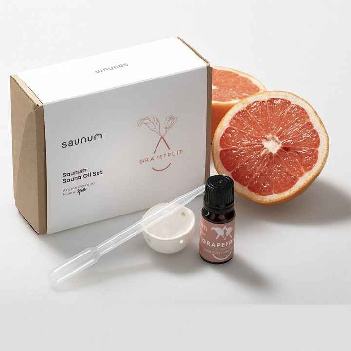 Saunum grapefruit sauna aroma oil set with essential oil bottle and grapefruit halves for a refreshing spa experience