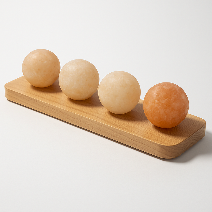 Saunum Himalayan salt spheres set on a wooden display for natural wellness and decor