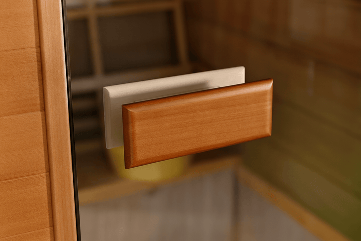 Door handle of a SunRay 2-person outdoor sauna made from natural wood for easy access