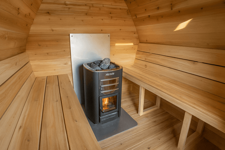 Leisurecraft traditional sauna interior with a heater and wooden benches, ideal backyard saunas for homes