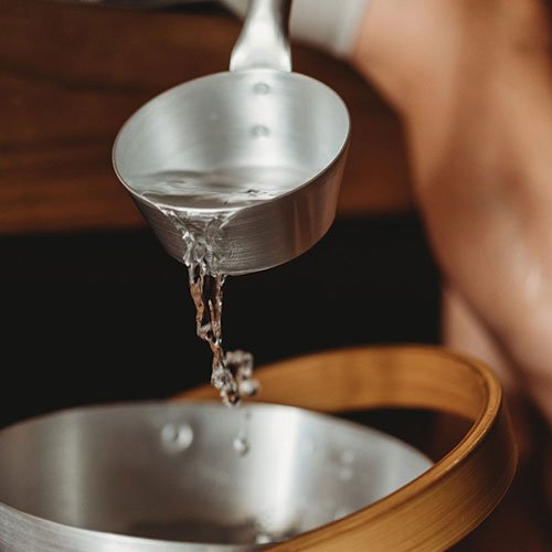 Rento Aluminum Measuring Cup Pouring Water with a Wooden Bowl for Accurate Kitchen Measurements