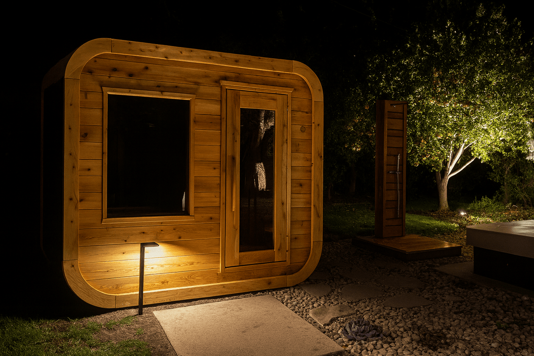 Leisurecraft outdoor luxury sauna made of natural wood, showcasing a modern design in a nighttime garden setting