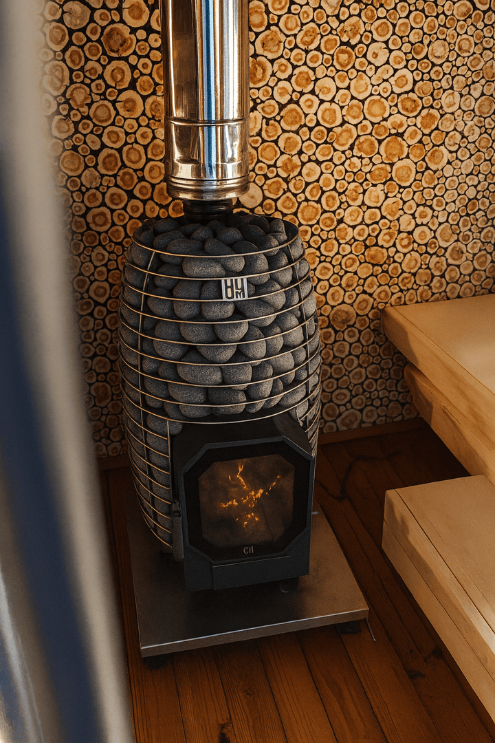 HUUM wood burning sauna stove featuring a sleek design and stone cover for efficient heating